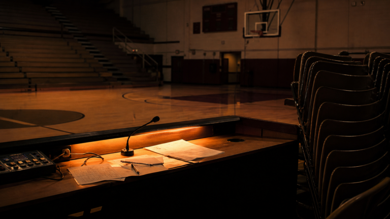 An empty community basketball gym after a local game.